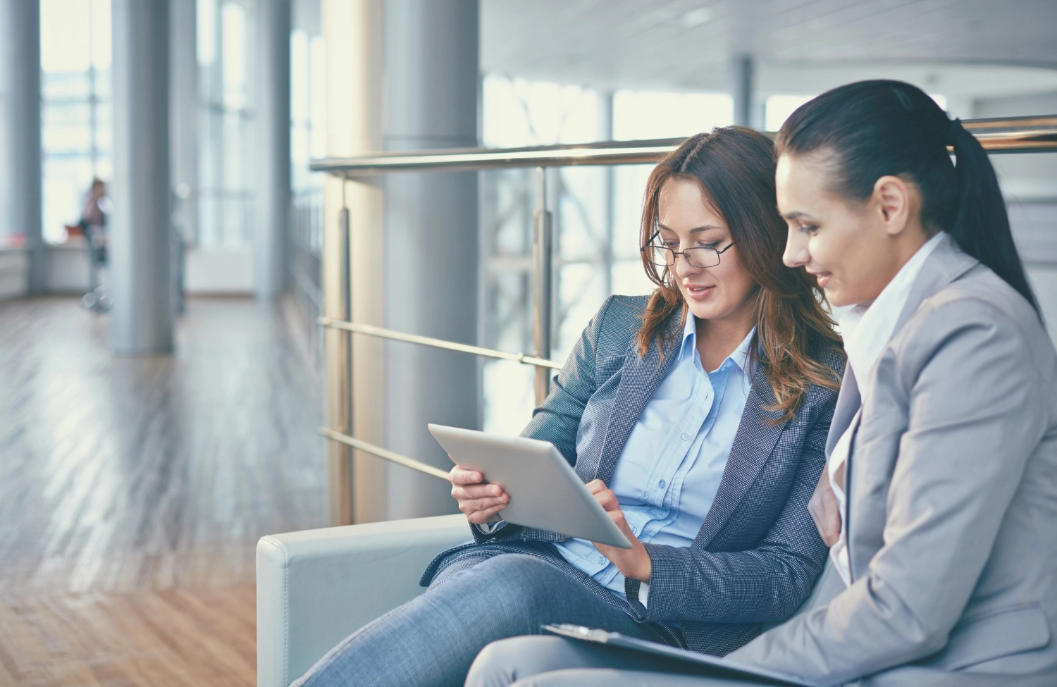 women-with-tablet-sitting-couch